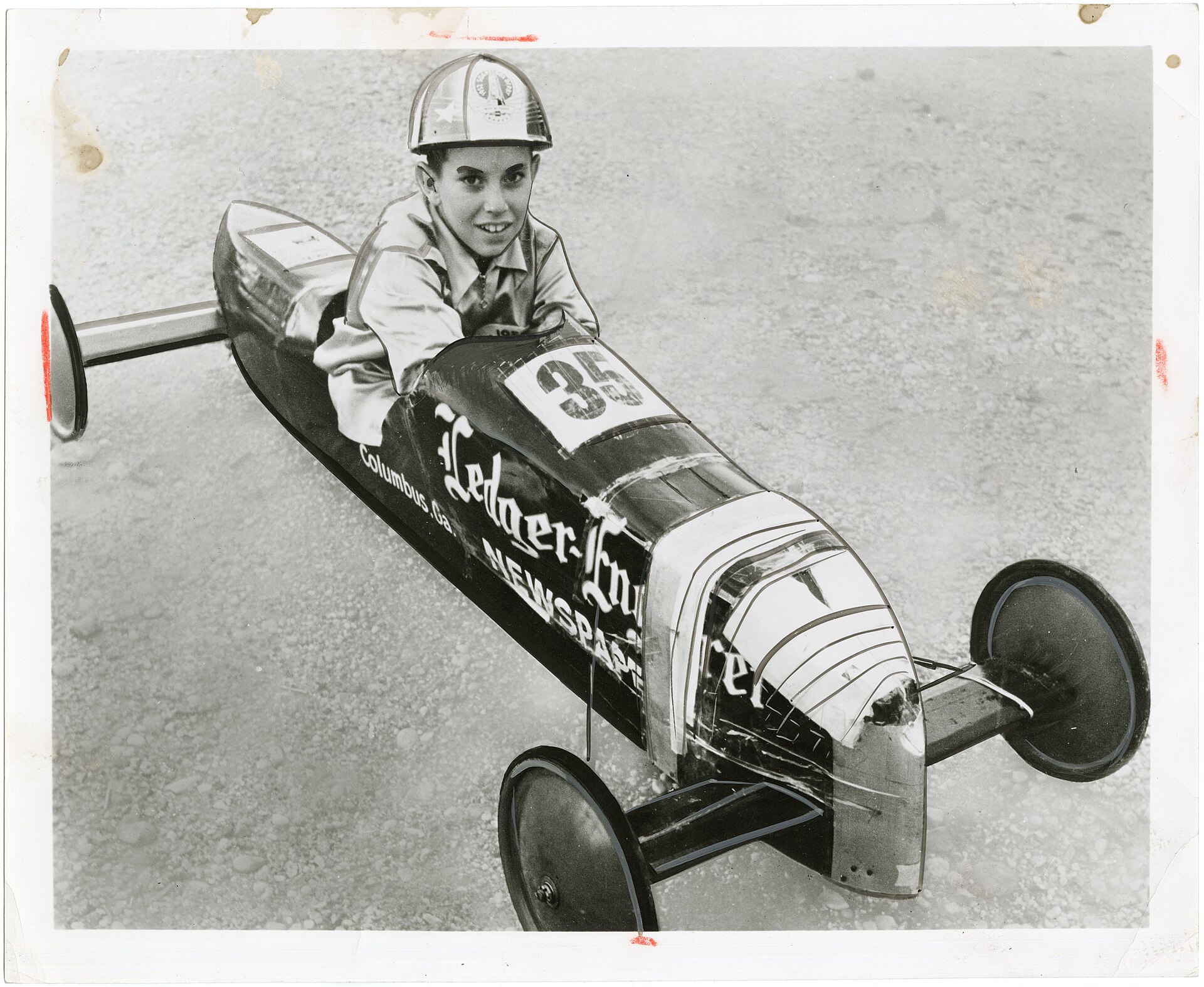 Eleven-year-old Joe Lunn seated in the narrow number 35 car that won the 1952 All-American Soap Box Derby