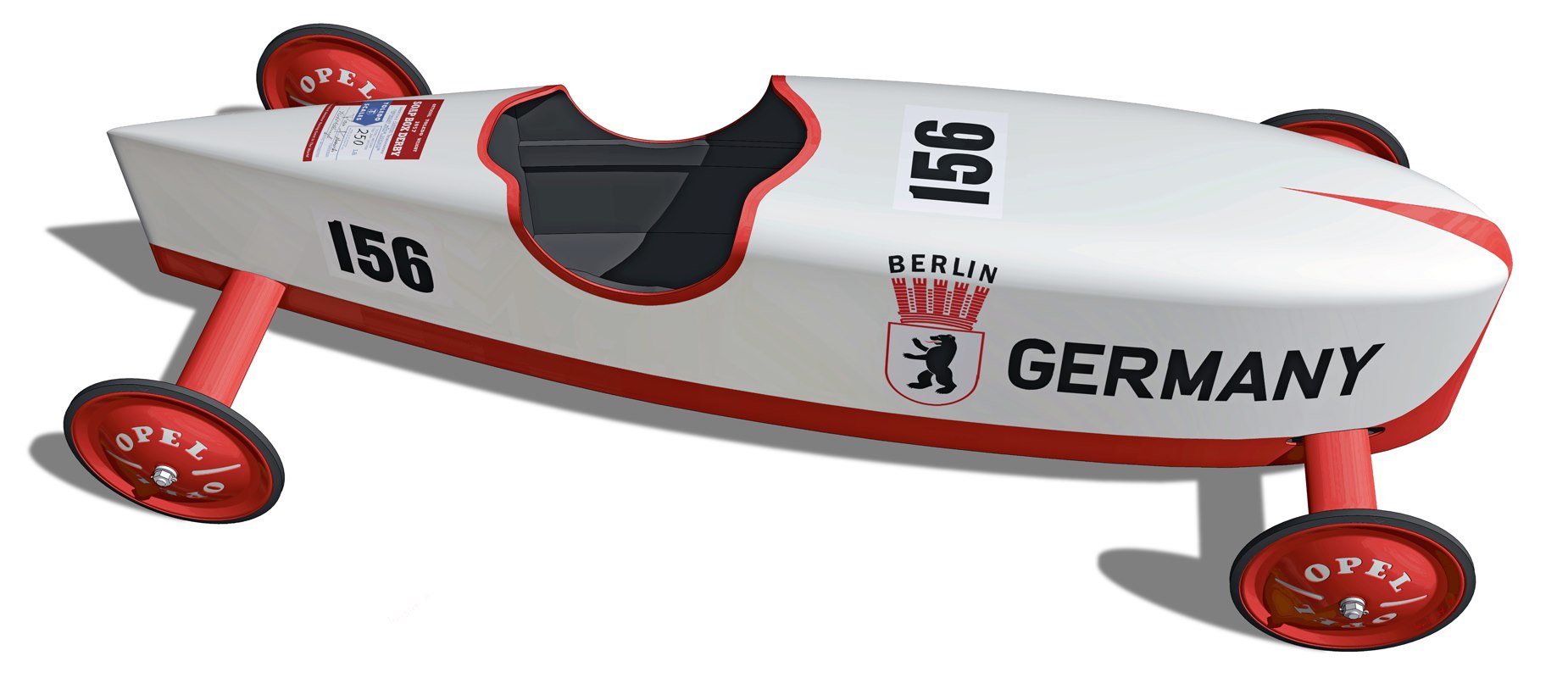 Profile view of a preserved 1952 German Soap Box Derby championship car with a rounded nose and open cockpit, on a plain backdrop
