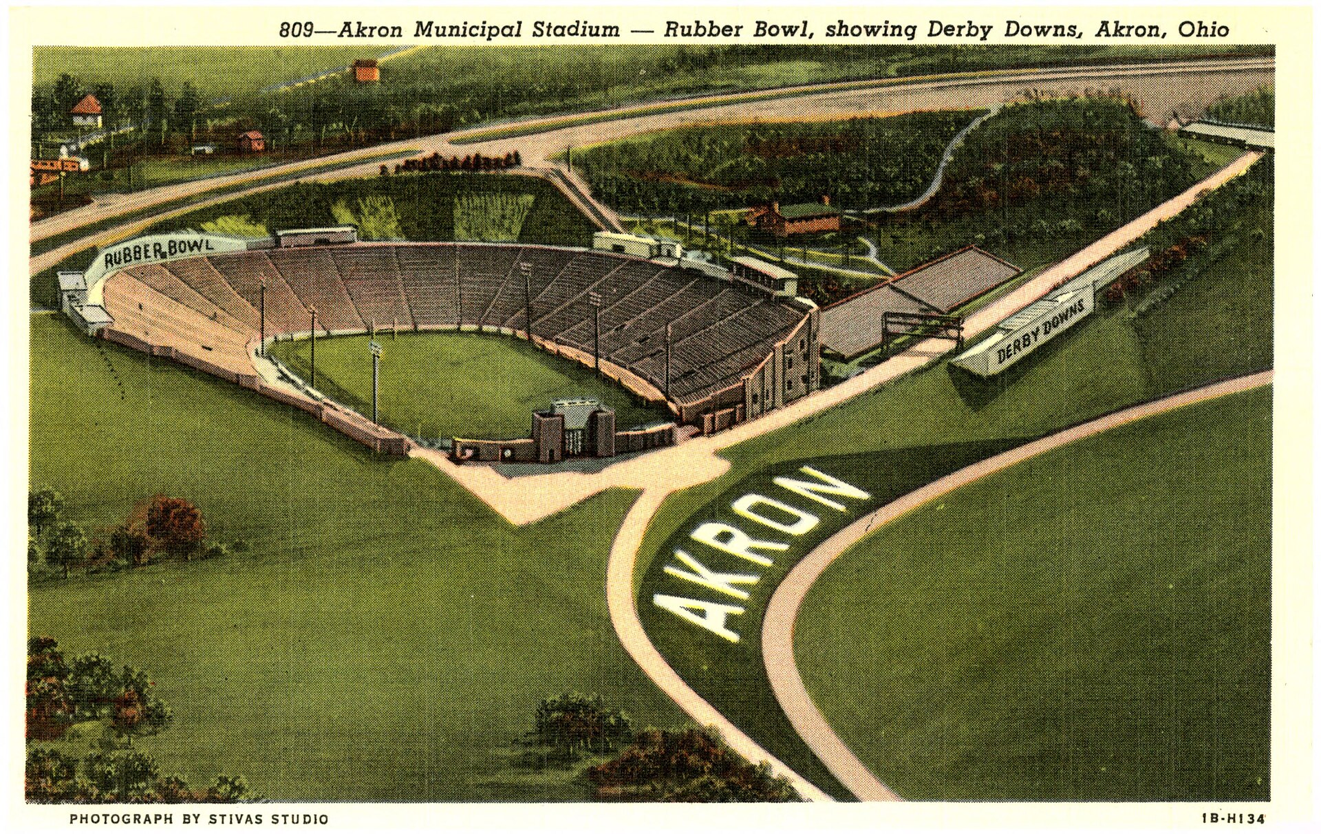 Color aerial postcard showing Akron Municipal Stadium, the Rubber Bowl, with Derby Downs nearby in 1940